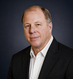 Howard Dreitzer in a black suit jacket and white shirt
